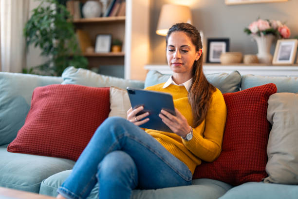 istock Portrait of a young woman using tablet at home 2154359748