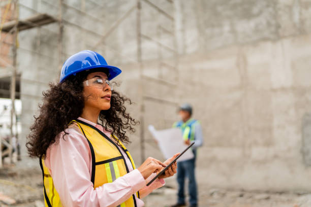 istock Mid adult architect woman using digital tablet on construction site 2154361563