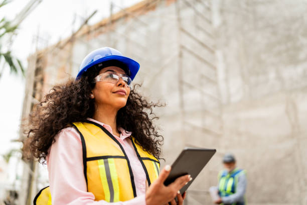 istock Mid adult architect woman using digital tablet on construction site 2154361615