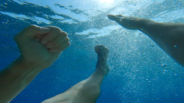 istock POV UNDERWATER: Terrified swimmer struggles to swim back to seawater surface 2154363584