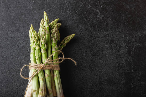 istock Green asparagus on a black background with copy space 2154366140