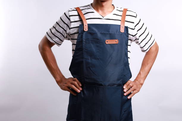 istock Crop anonymous male worker in apron standing with hands on waist. Isolated on white 2154367429