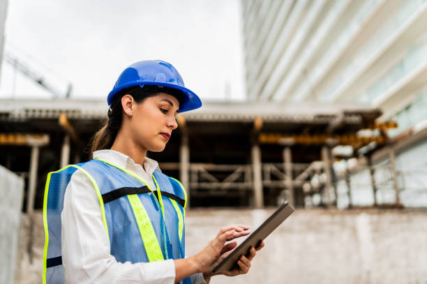 istock Mid adult architect woman using digital tablet on construction site 2154368096