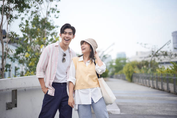 istock Two couple smiling and walking at town 2154371443