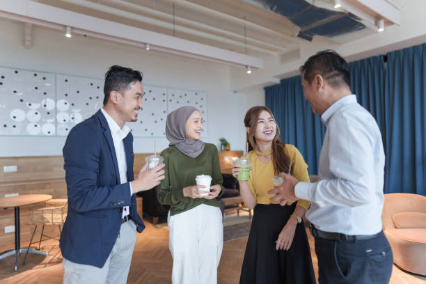 istock A diverse group of colleagues enjoying a casual conversation during a coffee break in a modern office lounge 2154371904