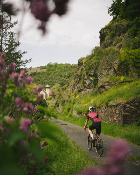 istock Road bicyclist rides country road 2154372183