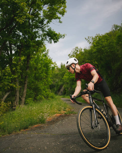 istock Road bicyclist rides country road 2154372184