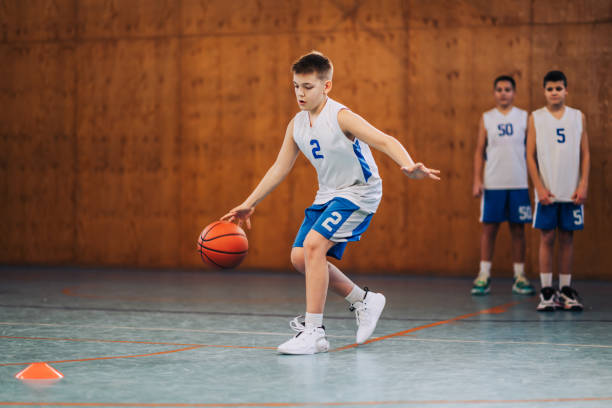 istock A junior basketball player in action dribbling a ball on training. 2154373050