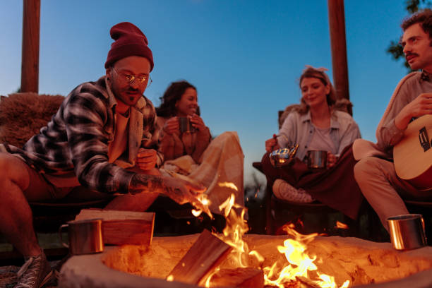 istock Four friends enjoying a cozy night by a campfire 2154373819