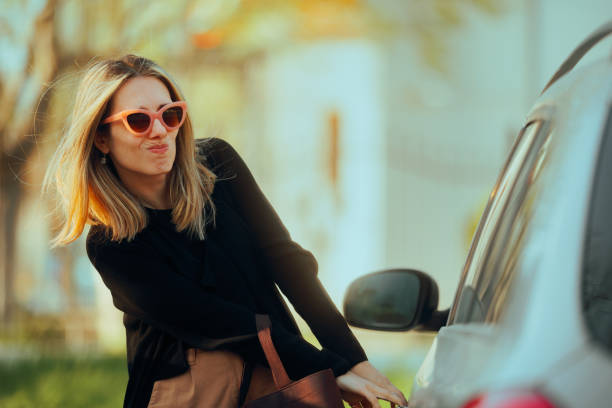 istock Desperate Woman Pulling on a Locked car Door 2154376017