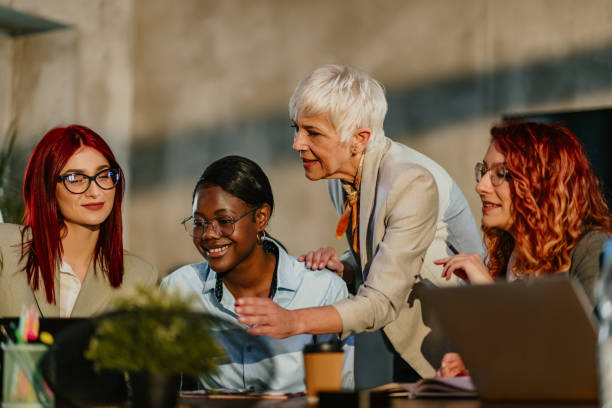 istock Interracial female team learning business strategy with their mentor. 2154380529