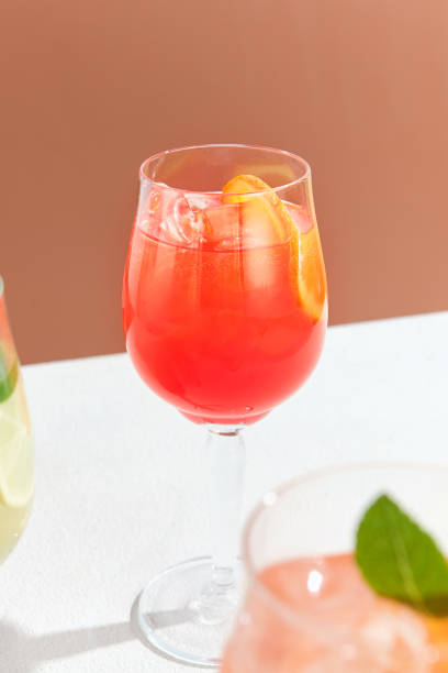 istock Refreshing Spritz Cocktail with Orange Garnish in Wine Glass Against Warm Background 2154381887