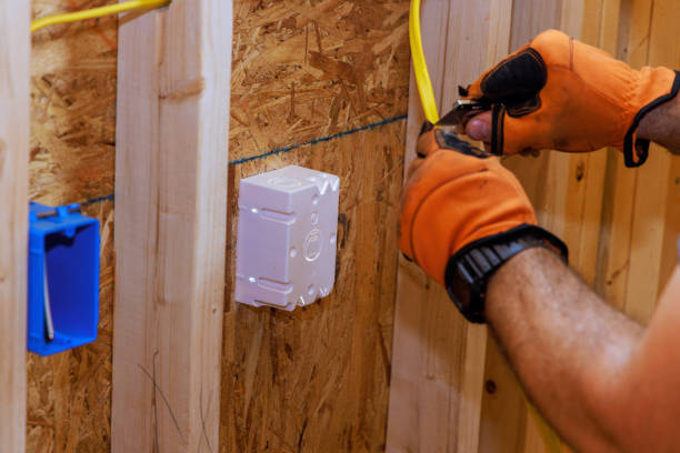 istock When a new building is being constructed, an electrician connects wires to socket box 2154384321