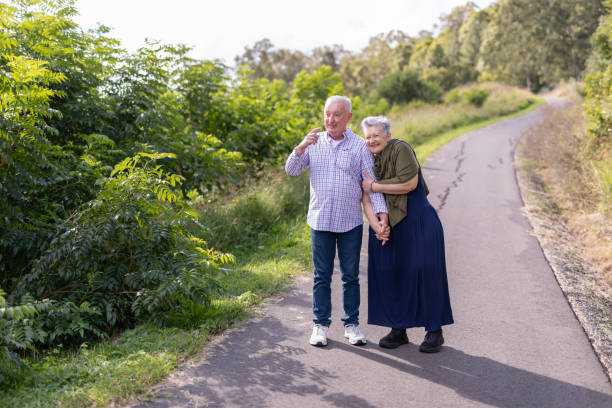 istock Senior couple walking together in a park 2154386939