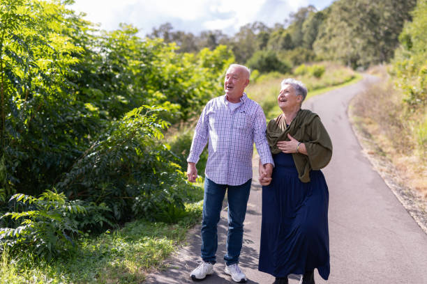 istock Senior couple walking together in a park 2154386941