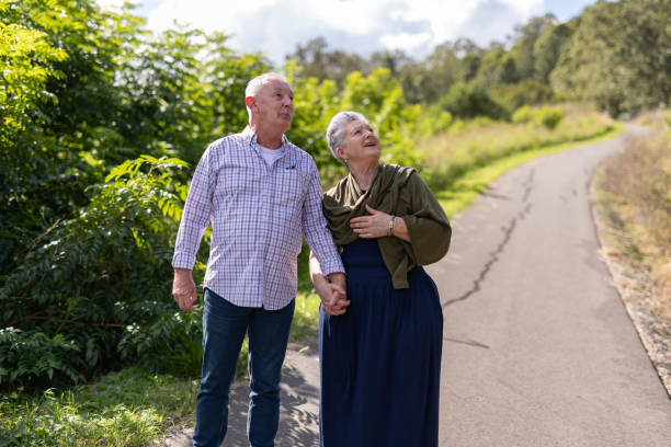 istock Senior couple walking together in a park 2154386942