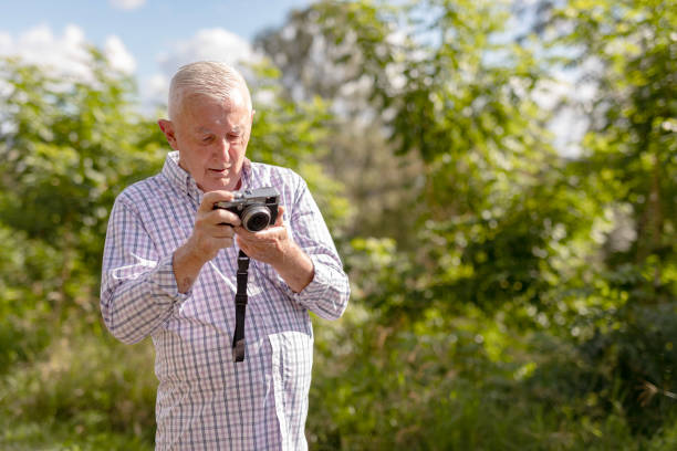 istock Senior Man Taking Photos in a Public Park 2154386944