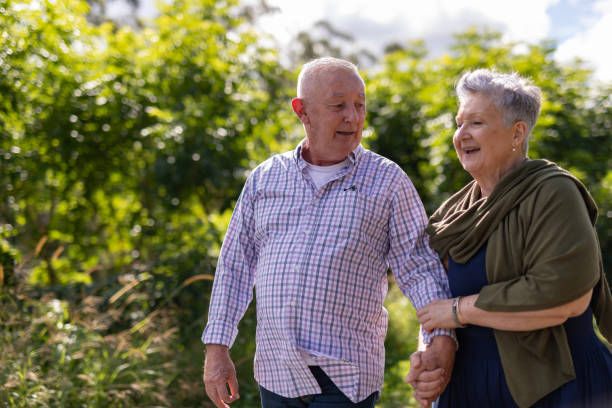 istock Senior couple walking together in a park 2154386953