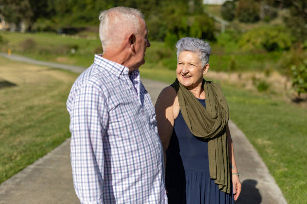 istock Senior couple walking together in a park 2154386955
