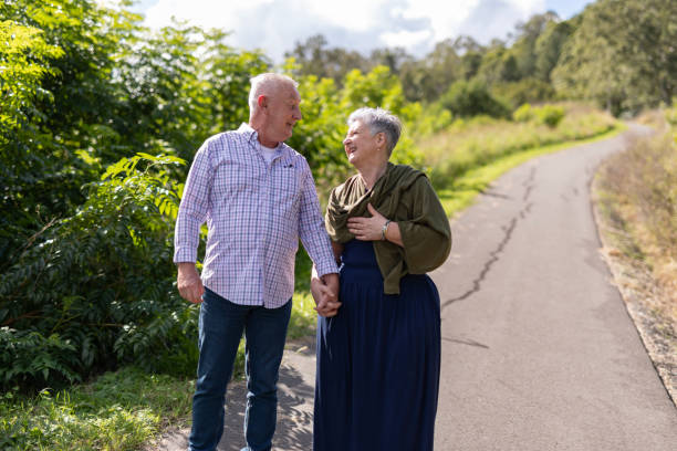 istock Senior couple walking together in a park 2154386966