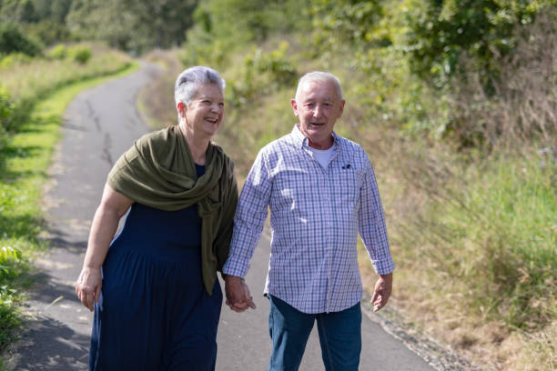 istock Senior couple walking together in a park 2154386968