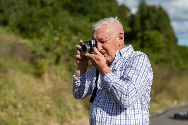 istock Senior Man Taking Photos in a Public Park 2154386972