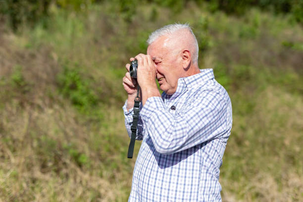 istock Senior Man Taking Photos in a Public Park 2154386974