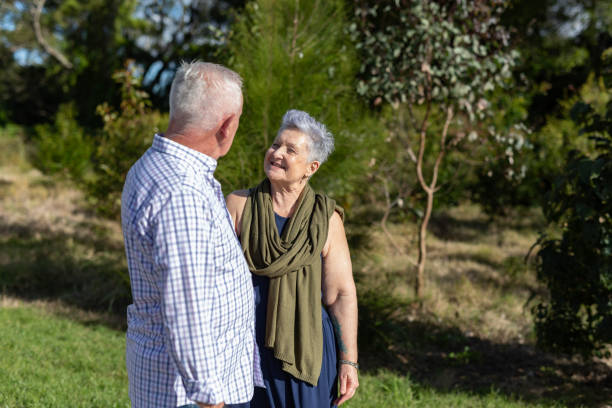 istock Senior couple walking together in a park 2154386975