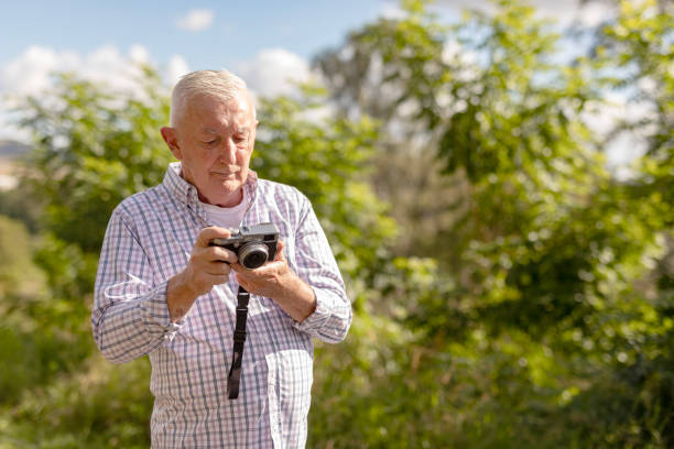 istock Senior Man Taking Photos in a Public Park 2154386981