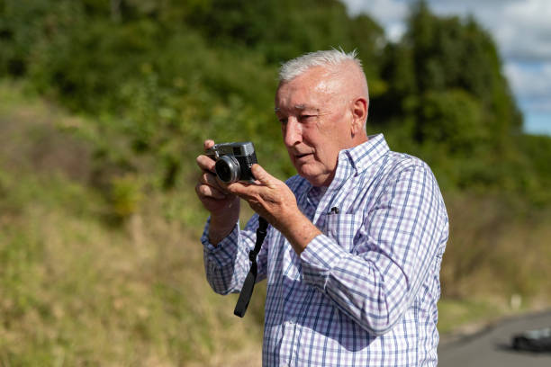 istock Senior Man Taking Photos in a Public Park 2154387101