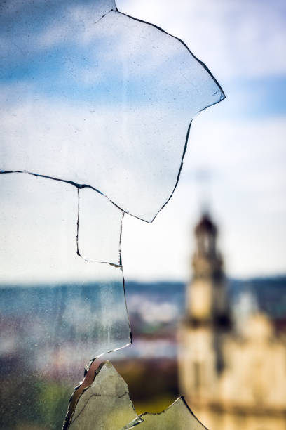 Church Bell Tower In City Panorama Through Dirty Broken Glass