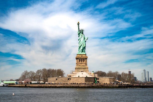 istock Statue of Liberty seen from the river in a clear blue sky 2154391395