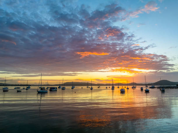 istock Aerial sunrise waterscape with boats, clouds and reflections 2154393698