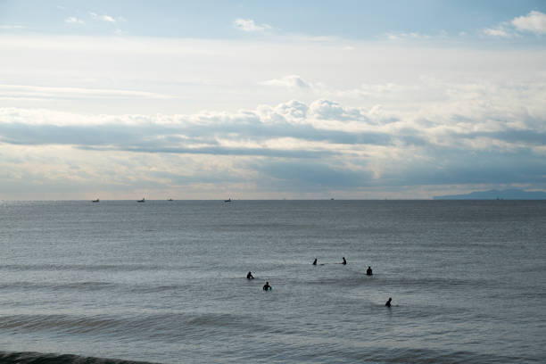 Beginner surfers heading offshore in the sea without waves