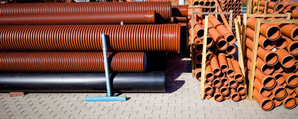 istock Warehouse of orange plastic sewer pipes. 2154398129
