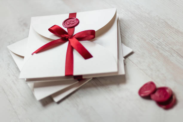 istock Wedding invitations with wax seal and ribbon on the table 2154402926