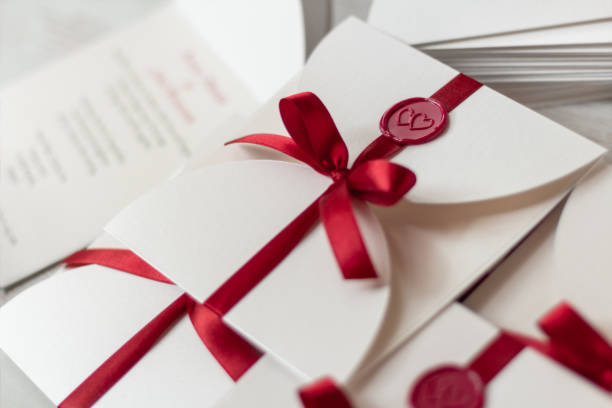 Wedding invitations with  red wax and red ribbon close up
