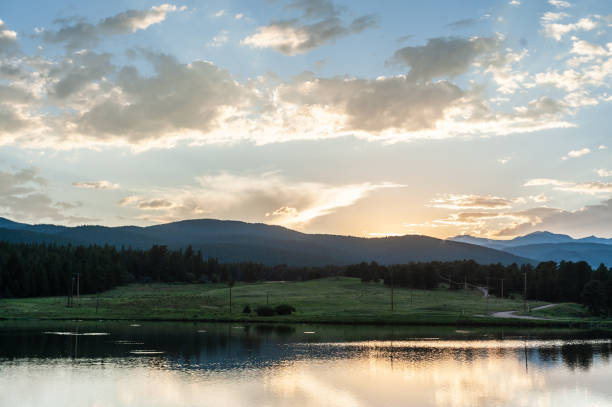 Sunset over a small Lake in the Colorado Rocky Mountains, known as Los Lagos Reservoir Number three. Near Kelly Dahl Campground and the Town of Nederland, CO.