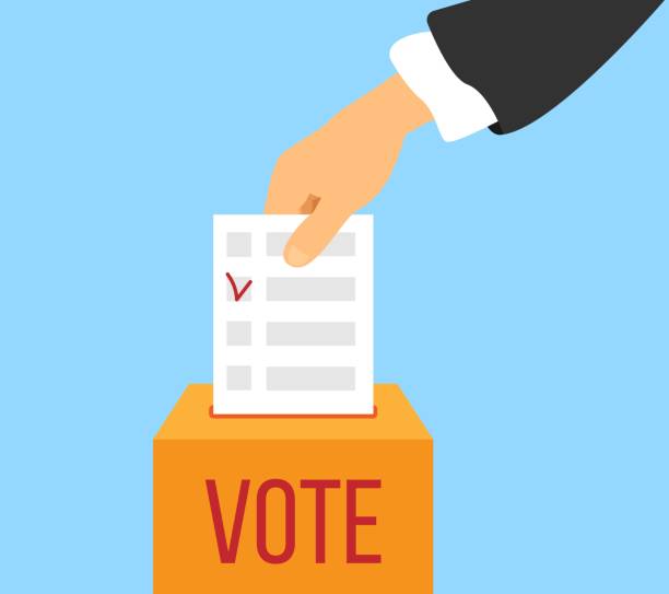 istock Hand of a Businessman Holding a Vote Bulletin During Election 2154406476