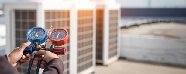 istock Air conditioning, HVAC service technician using gauges to check refrigerant and add refrigerant. 2154407317