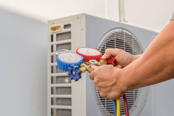 istock Air conditioning, HVAC service technician using gauges to check refrigerant and add refrigerant. 2154407812