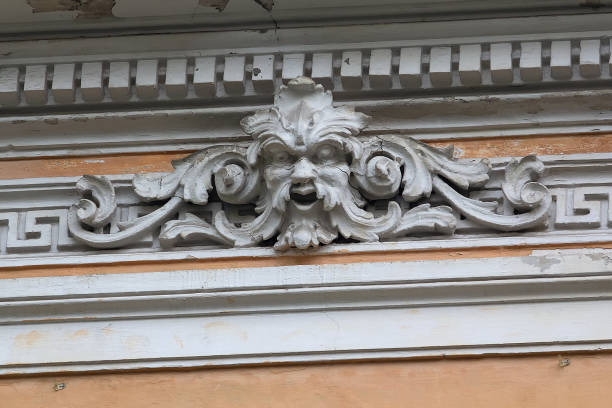 istock Bas-relief with a human head on the facade of an old building 2154411407