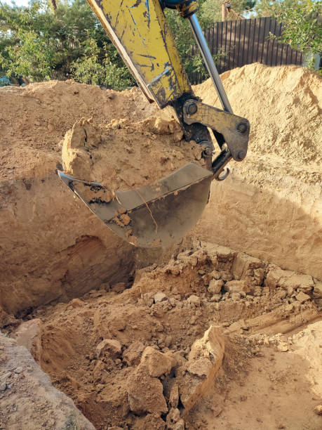 istock Digging the pit foundation a hole with excavator at the construction site. Excavator digging a hole into the ground 2154411723
