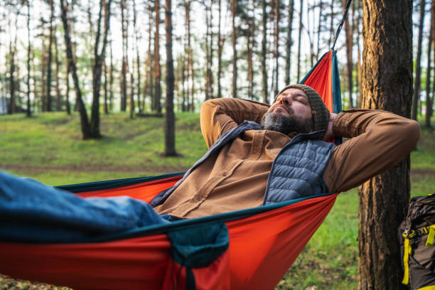 istock Traveler resting  in hammock in the pine tree woods 2154413583