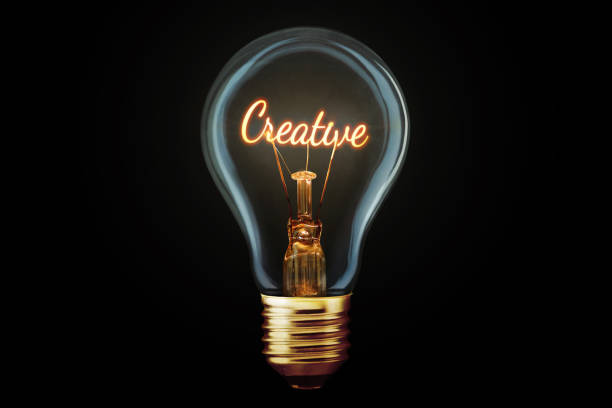 istock Creative light bulb with a spiral Creative glows on a black background, concept. Thought generator, creative idea. Think differently. Marketing. Growth and learning 2154414798