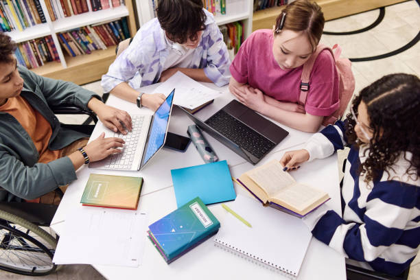 istock Diverse Group of Students in Library Doing Research 2154414936