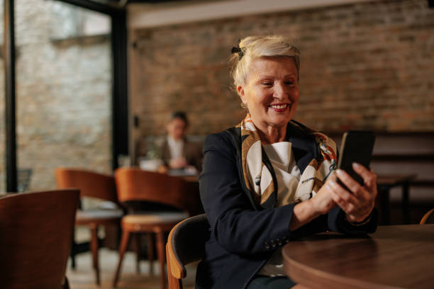 istock Joyful businesswoman using a cellphone in a cafe. 2154415022