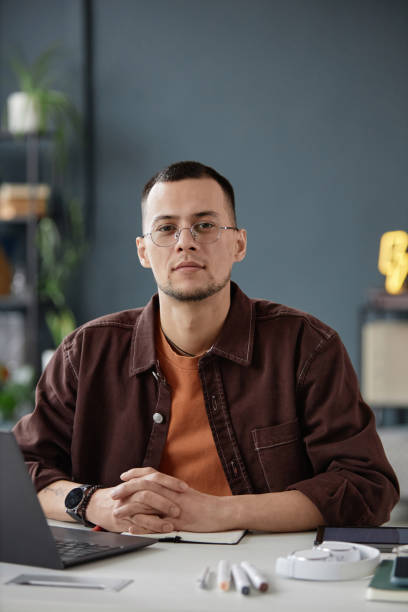 istock Asian Man Sitting at Workplace in Office 2154415704