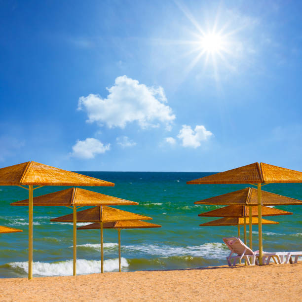 summer sea beach with sun umbrella at sunny day