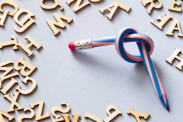 istock Pencil with knot and scattered letters, dyslexia concept 2154420945